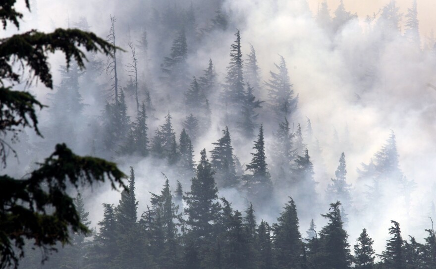 As in Washington, fire conditions in Oregon are high. In this photo the Dollar Lake fire smolders Tuesday near Laurance Lake, on Mount Hood, Ore. Firefighters labored to build containment lines before windy conditions return early this morning.