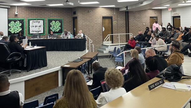 Peoria School Board 150 meeting March 23. The public looks across a horseshoe divider as committee members on a stage across the room deliberate.