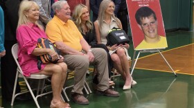The Moyer family, including mom Rachel, dad John and daughters Katie and Abbie, sit next to a picture of their son and brother. Greg Moyer died in 2000 after suffering a sudden cardiac arrest during halftime of a basketball game.