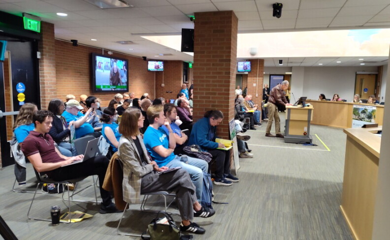 A resident speaks at the podium during Ann Arbor City Council's October 5, 2026, meeting.