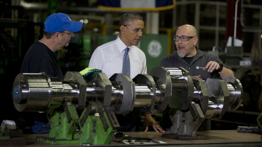 President Barack Obama looks at a crank shaft as he tours General Electric's Waukesha Gas Engines facility on Thursday in Waukesha, Wis. as part of a four-stop tour he is making to expand on themes from his State of the Union address, including the economy.