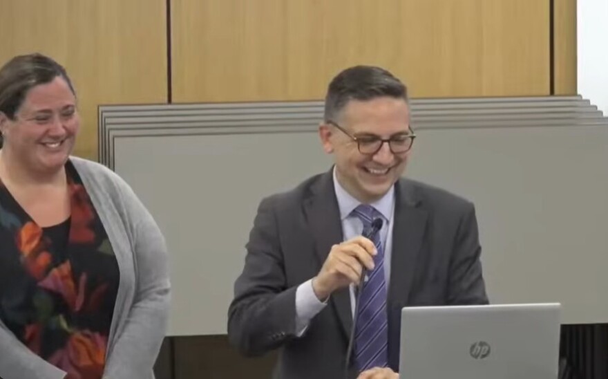 Deputy Superintendent Mark Fleming (right) speaks at a school board meeting on June 16, 2026.