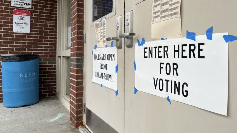 Signs outside a polling place in Keene, N.H., read: "POLLS ARE OPEN FROM 8:00 AM-7:00PM" and "ENTER HERE FOR VOTING."
