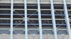 Inmates raise their fists from inside the Brooklyn jail, where they went without heat and electricity for a week.