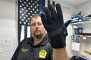 Nelson County, Ky., jailer Justin Hall shows an electric shock glove that is used at his facility, Thursday, Aug. 13, 2026, in Bardstown, Ky. (AP Photo/Dylan Lovan)