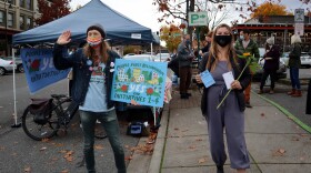 People First Bellingham campaign volunteers Seth Mangold and Sage Jones sought voter support for their coalition's four initiatives at the Bellingham Farmers Market on Saturday.