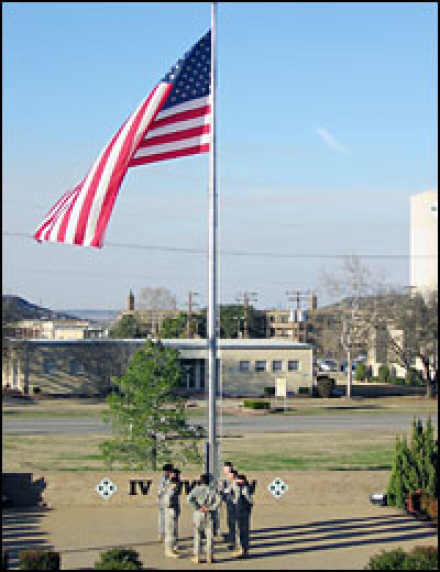 Soldiers lower the flag outside division headquarters at 5 p.m. on a recent day.