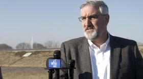 Gov. Eric Holcomb speaks with reporters after an I-69 ribbon cutting ceremony in Martinsville.