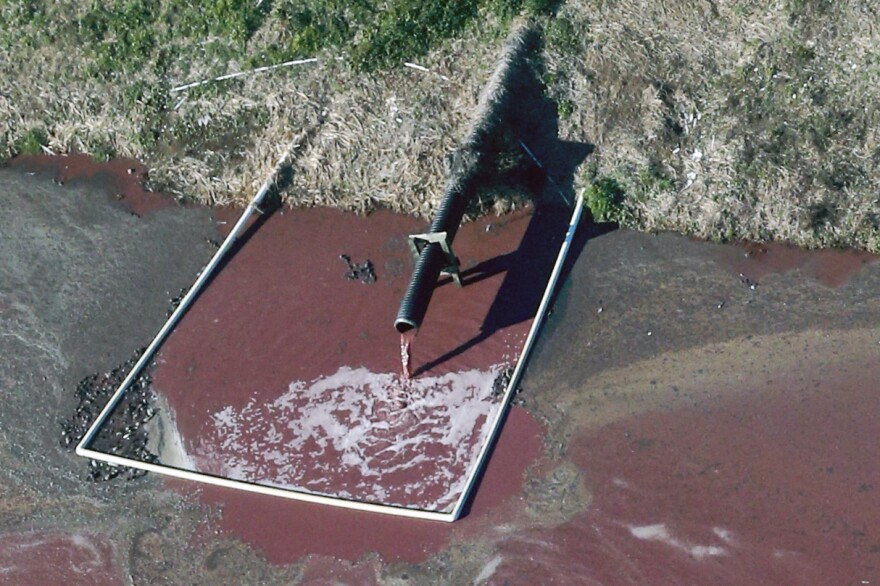 A hog facility in Duplin County, N.C. discharges waste into a manure lagoon, April 2015.