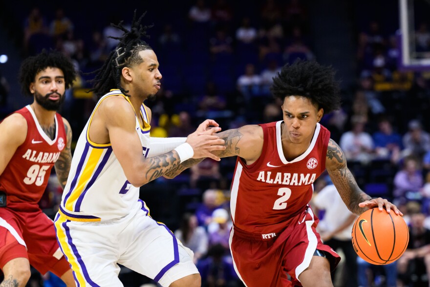 Alabama guard Aden Holloway (2) runs the ball against LSU guard Jalen Reece (2) during the second half of an NCAA men's basketball game in Baton Rouge, Saturday, Feb. 21, 2026. (AP Photo/Ella Hall)