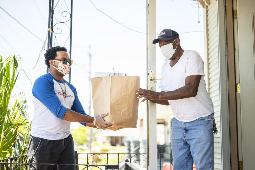 Jose Fermin Ceballos from the Krewe of Red Beans delivers produce and grocery items to Benny Jones, a local drummer and the leader of the Treme Brass Band, as a part of their Feed The Second Line fundraising effort.