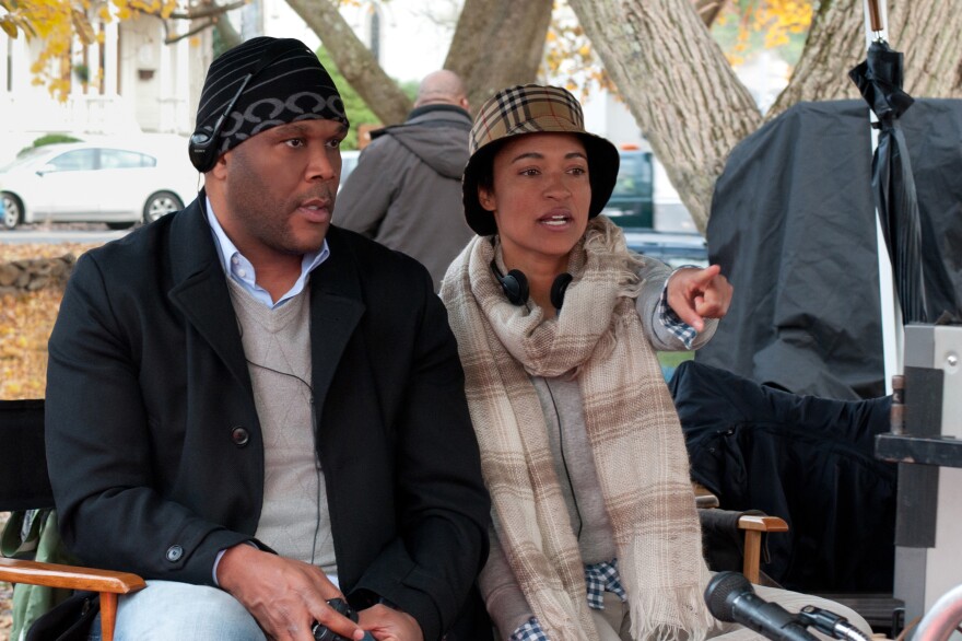 Writer-director Tina Gordon Chism sits on the set of <em>Peeples</em> with producer Tyler Perry, who also wrote and directed <em>Temptation</em> and <em>A Madea Christmas</em> this year.