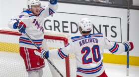 New York Rangers right wing Arthur Kaliyev and New York Rangers left wing Chris Kreider (20) celebrate Kaliyey's goal, during the first period of an NHL hockey game, Thursday, Jan. 16, 2025, in Salt Lake City. (AP Photo/Rick Egan)