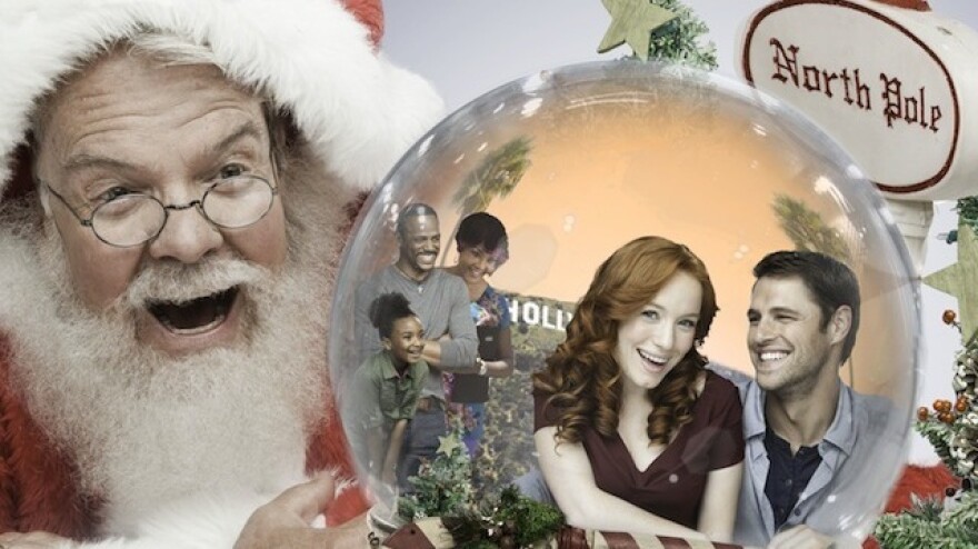 Why yes, this is a promotional image for a real holiday Hallmark movie called Annie Claus Is Comin' To Town. That's Annie Claus, Santa's daughter, inside the snow globe being stared at by her father.