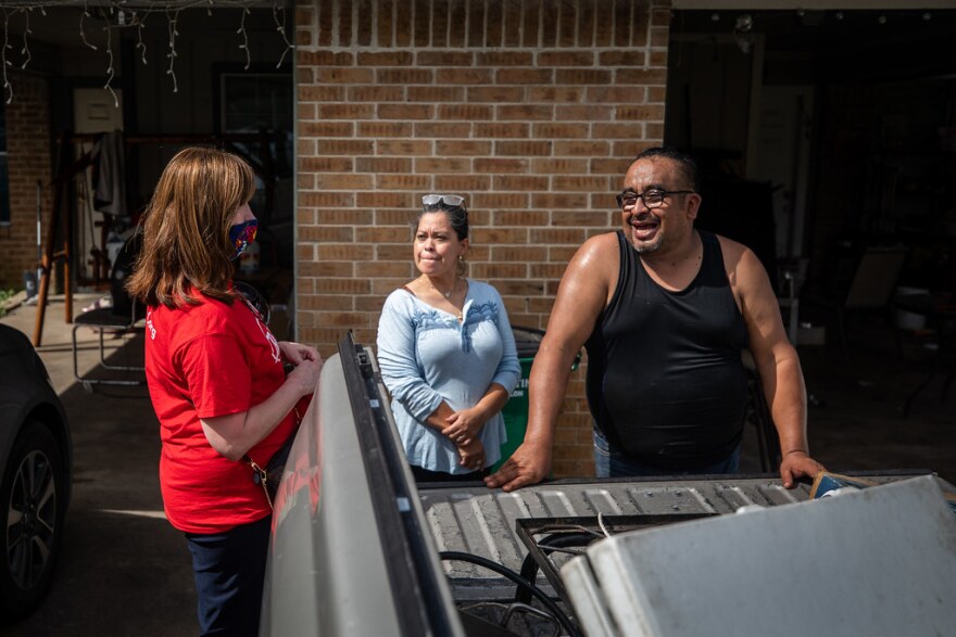 Austin ISD Superintendent Stephanie Elizalde speaks with Araceoy Castro and Joel Agurre outside their home during AISD’s Operation Reconnect, an in-person push to get families to enroll in the district.