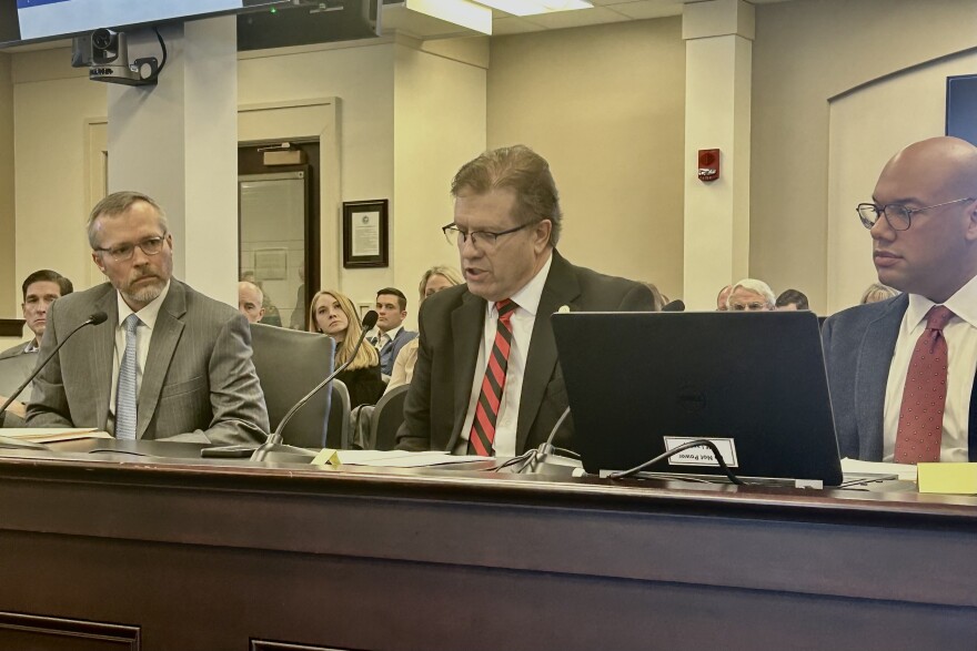 Republican Sen. Scott Madon discusses his bill to change the definition of "waters of the Commonwealth" in anti-pollution laws while flanked by Tucker Davis, president of the Kentucky Coal Association, and R. Clay Larkin, a lawyer also with the coal association.