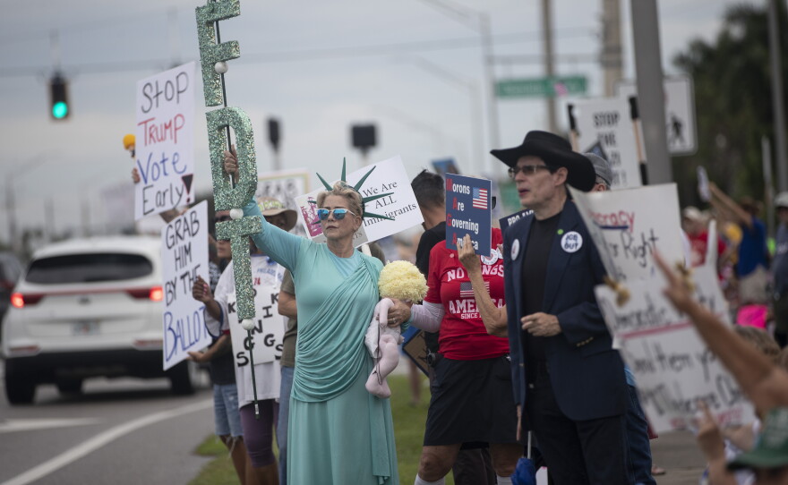 People gather along U.S. 41 in Fort Myers on Saturday morning, October 17, 2026, to advocate for change ahead of the mid-term elections. Organizers estimate about 1,000 people came out for the event.