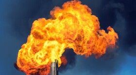 Billowing fiery smoke pours out of a factory.