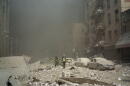 FIremen walk through a dust and debris covered street in lower Manhattan Tuesday, Sept. 11, 2001, after a terrorist attack at the World Trade Center. (Richard Cohen/AP)