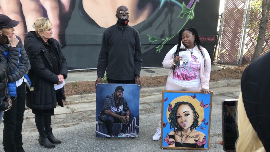 Photo by Paul Bibeau. Wayne Lynch, father of Donovon Lynch, and Elisheba Harris, mother of Deshayla Harris, hold portraits of their children. Donovon Lynch and Deshayla Harris died in shootings at the Oceanfront last year.