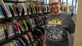 Gretchen Robinson, a lesbian high school teacher in Orange County, Fla., poses for a photo at the downtown library, Saturday, Aug. 13, 2022, in Orlando, Fla. Educators are cautiously making changes as they wait to see how the new law governing lessons on gender and sexual orientation will be interpreted and enforced. (AP Photo/John Raoux)