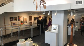 People tour the newly reopened Lansing Art Gallery and Education Center inside the Knapp's Centre downtown on Tuesday, Feb. 1, 2022.