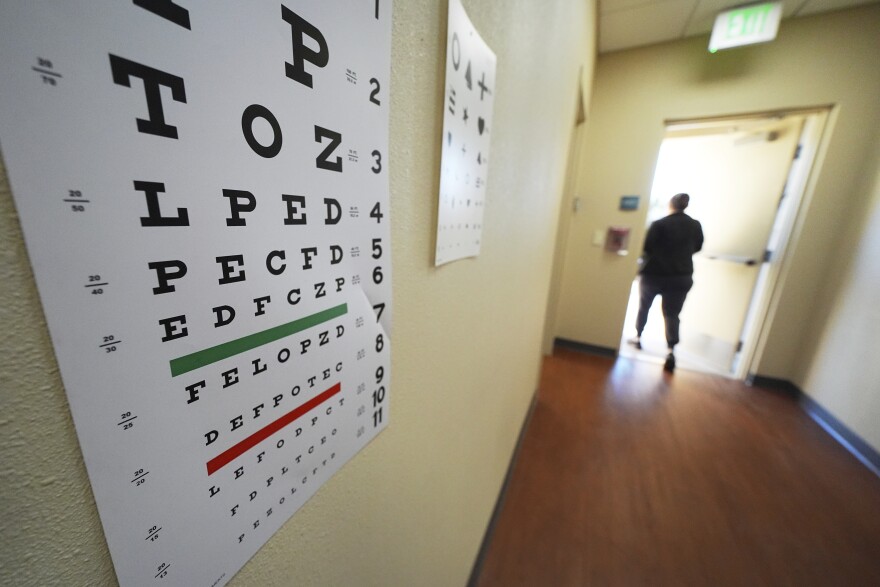 Eye exam posters are seen outside a clinic's exam room Monday, Feb. 24, 2025, in Hobbs, N.M. (AP Photo/Julio Cortez)