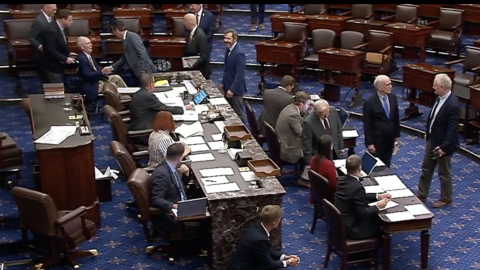 Sen. Mitch McConnell, wheeled out in a wheelchair, casts his first roll call vote since he was hospitalized after a fall in June.