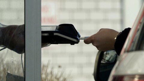 FILE - A card reader is used at a drive-thru restaurant.