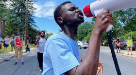 Alaak Deu uses a bullhorn to lead a Black Lives Matter protest outside the Lancaster Recreation Center where Democratic presidential candidate Joe Biden was planning to speak on health care on Thursday, June 25, 2020. (Kate Landis/WITF)