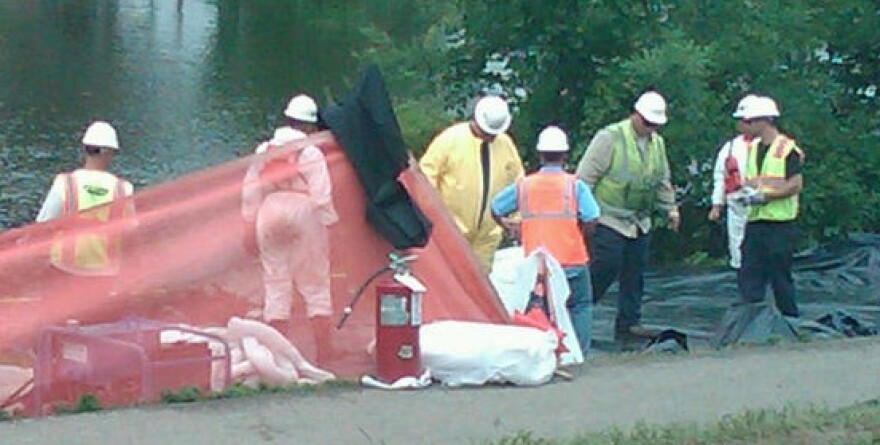 Clean up workers along the Kalamazoo River in Battle Creek in August, 2010