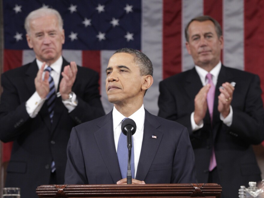 President Barack Obama is applauded by Vice President Joe Biden and Speaker of the House John Boehner while delivering his State of the Union address on Capitol Hill.