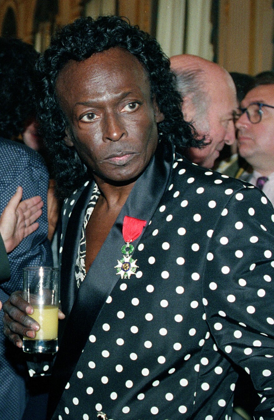 FILE - In this July 16, 1991 file photo, jazz great Miles Davis is pictured after receiving the Chevalier de la Legion d'Honneur award medal from the French government in Paris. Davis wasn't even listed in the program book when he appeared for the first time at the Newport Jazz Festival in 1955, but he made his presence felt with a career-reviving performance in an all-star jam session. This year's program book is Miles-centric as the festival, which begins July 31, celebrates the 60th anniversary of the late jazz legend's historic Newport debut. (AP Photo/Remy de la Mauviniere, File)