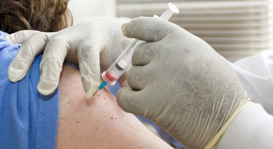 A flu shot being given