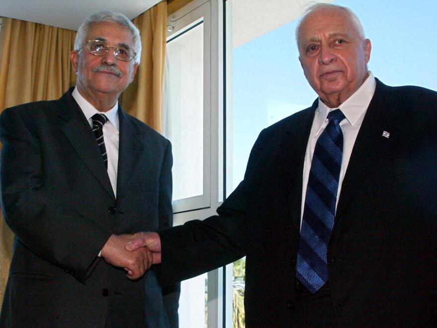 Palestinian leader Mahmoud Abbas (left) and Israeli Prime Minister Ariel Sharon shake hands before their summit meeting in Sharm El-Sheikh, Egypt, on Feb. 8, 2005. Abbas and Sharon declared a cease-fire to end four years of deadly violence. Since then, there have been long periods of low-level violence, punctuated by brief, intense bouts of killing.
