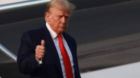 Former U.S. President Donald Trump gives a thumbs up as he arrives at Atlanta Hartsfield-Jackson International Airport in Atlanta, Georgia. (Joe Raedle/Getty Images)