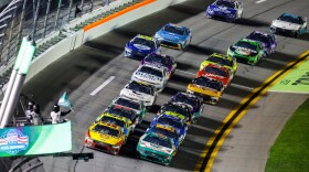 Cars move on the track during the first of two NASCAR Daytona 500 qualifying auto races at Daytona International Speedway, Thursday, Feb. 12, 2026, in Daytona Beach, Fla. (AP Photo/David Graham)