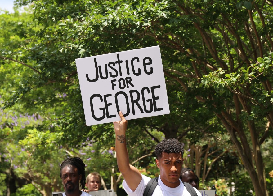 People protest the death of George Floyd in Charleston.  The Minneapolis man died while being retrained by police.  May 2020