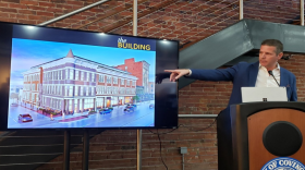 Guy van Rooyen, president of the Salyers Group, shows off the new plans for the former downtown Covington YMCA building.