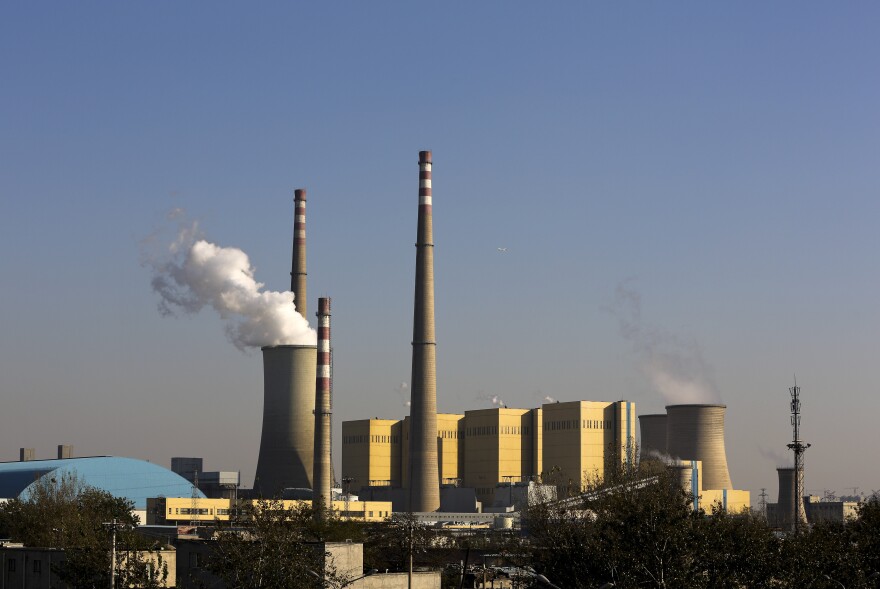 Smoke billows from a coal-fired power plant in Beijing on Thursday. For an international summit earlier this week, China temporarily closed factories and the skies were less polluted for a couple days.