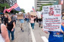People protesting march with signs.