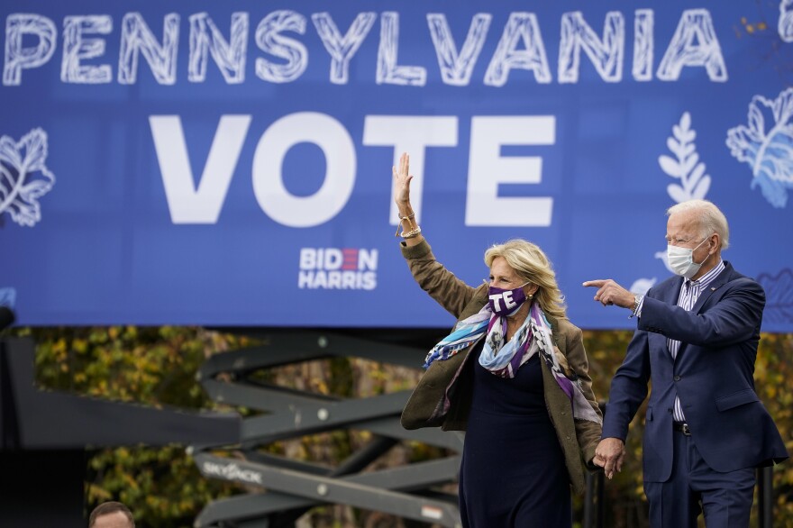 Joe Biden and his wife, Jill Biden, arrive for a drive-in campaign rally last month at Bucks County Community College near Philadelphia. Bucks County and three other suburban Philadelphia counties helped the president-elect win the swing state.