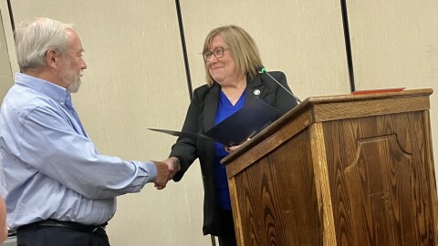 Mayor Lilija Stevens presents a proclamation to Washington resident Al Ponto that recognizes his heroic actions that alerted his neighbors to a fire at their home.