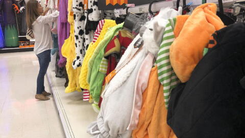 A customer looks through kids Halloween costumes at a Target department store on Tuesday, Oct. 2, 2018, in Aventura, Fla. (Brynn Anderson/AP)