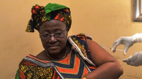 A woman is vaccinated at a health center in Conakry, Guinea, during the clinical trials of a vaccine against the Ebola virus.