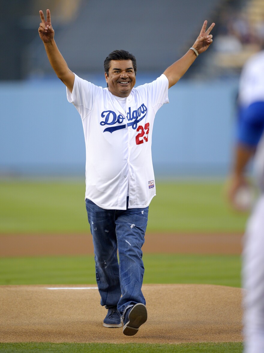Comedian George Lopez leaves the mound after throwing out the ceremonial first pitch prior to the Los Angeles Dodgers' baseball game against the New York Mets on Wednesday.