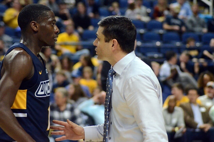  UNCG guard Isaiah Miller chats with head coach Wes Miller during a game in 2019 at the Greensboro Coliseum.