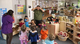 Early education teachers leading preschool age children (3-4 yrs) in play and games activities,