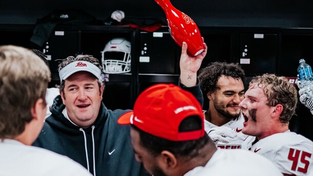 University of New Mexico Head Football Coach Jason Eck holds a bowling bin emblazoned with the words "Bowl Bound" following UNM's 40-35 victory over the University of Nevada-Las Vegas on Nov. 1.