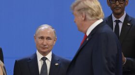 US President Donald Trump looks at Russian president Vladimir Putin during a photo at the G20 Leaders' Summit. 